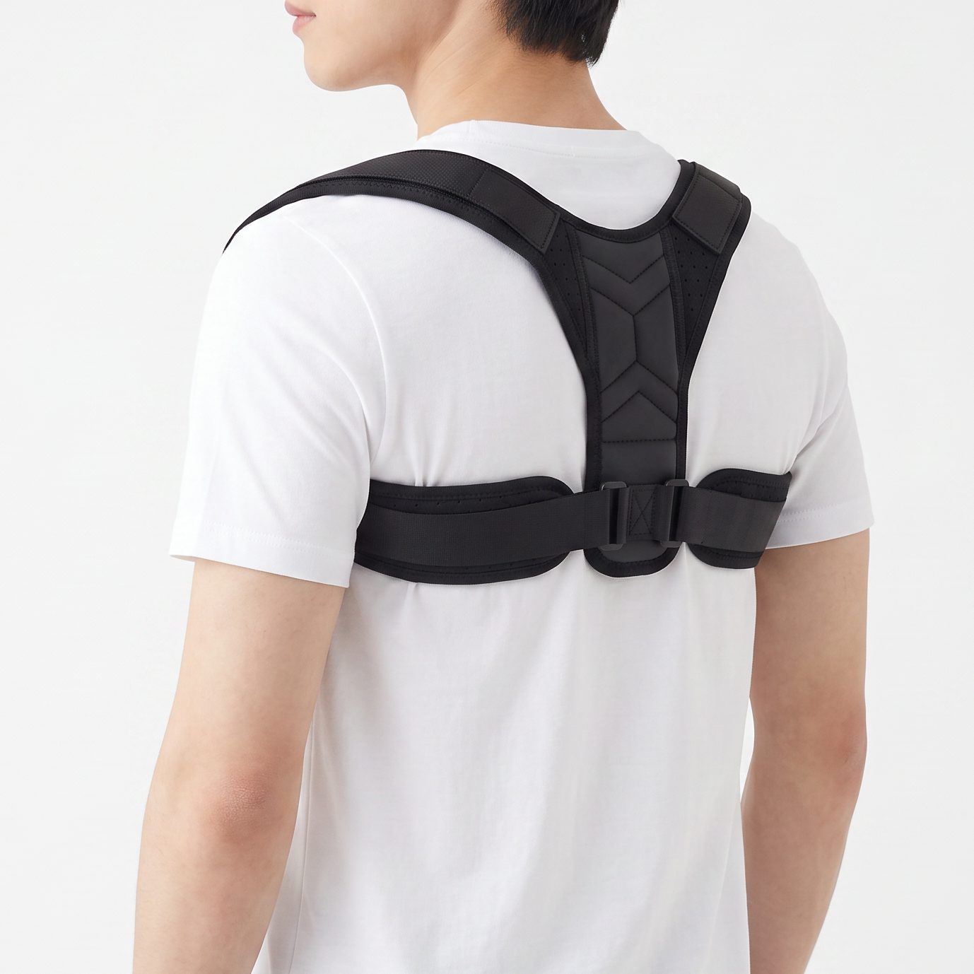 Man wearing the black ExoPosture Air posture corrector, three-quarter back view. black-air1 black-air2 black-air3 black-air4 black-air5