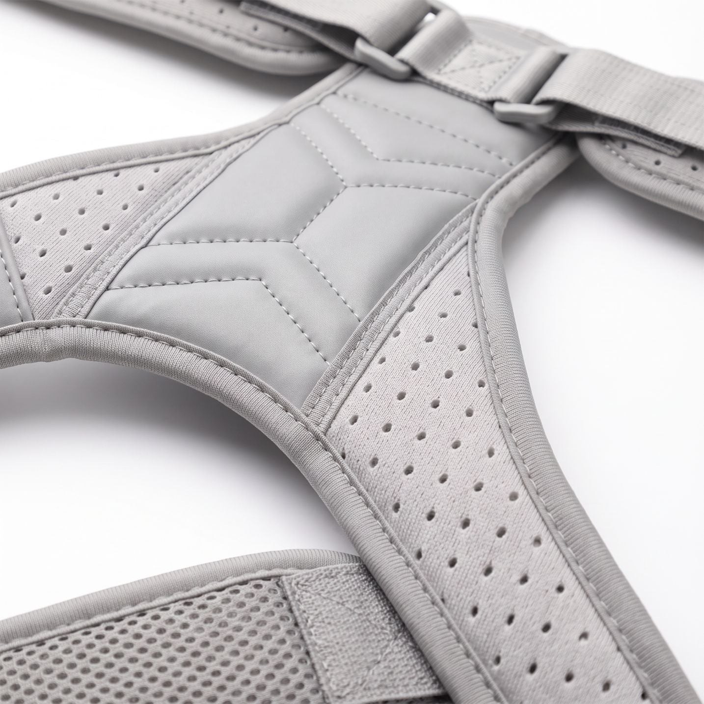 Close-up of the breathable perforated mesh on the gray ExoPosture Air posture corrector. gray-air1 gray-air2 gray-air3 gray-air4 gray-air5