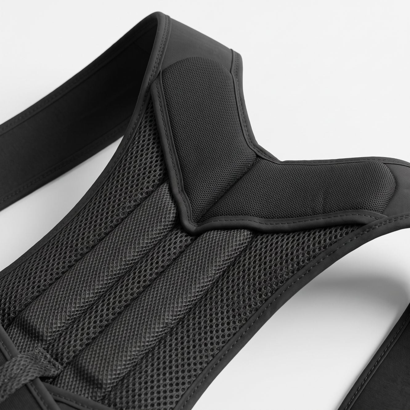 Close-up of the padded shoulder straps on the black ExoPosture Max posture corrector.